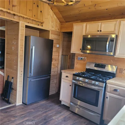 a kitchen with granite countertop a stove and a refrigerator