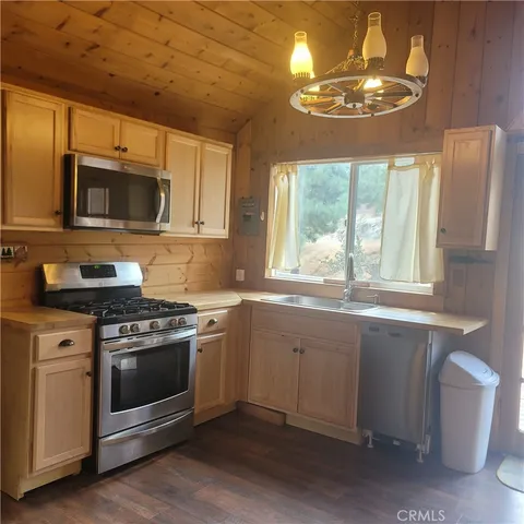 a kitchen with stainless steel appliances granite countertop a stove and a microwave