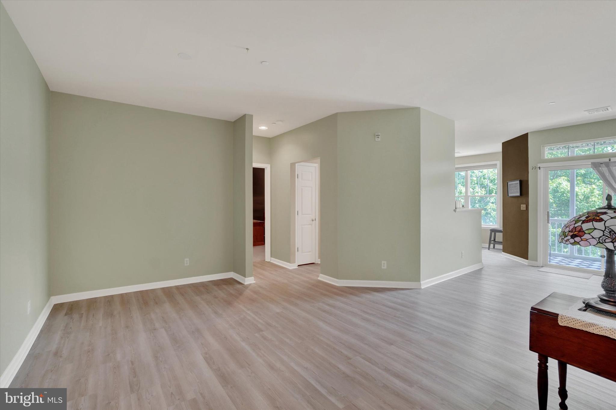 1010 Crest Way, Unit 304 York, PA 17403 - Photo 14 of 24 a view of an empty room with wooden floor and a window