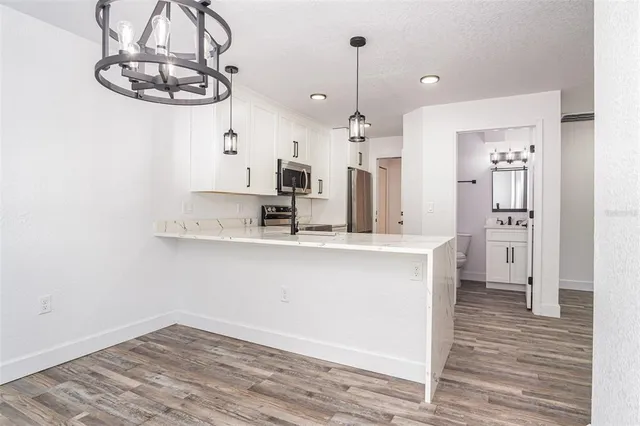 a view of a kitchen from a hallway