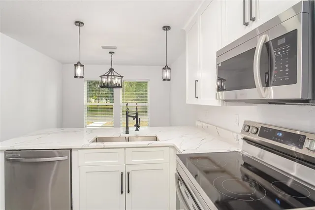 a kitchen with a sink and a stove