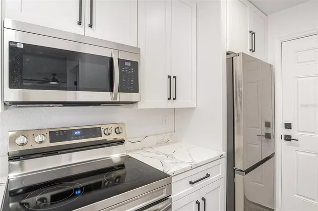 a kitchen with appliances and cabinets
