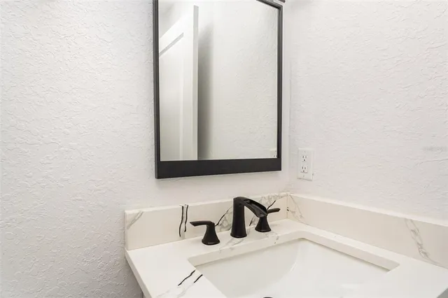 a bathroom with a sink and mirror