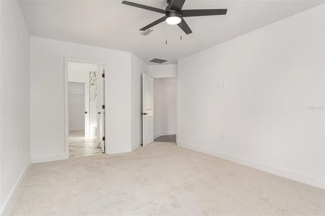 a view of a room with a ceiling fan