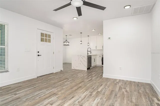 a view of empty room with wooden floor