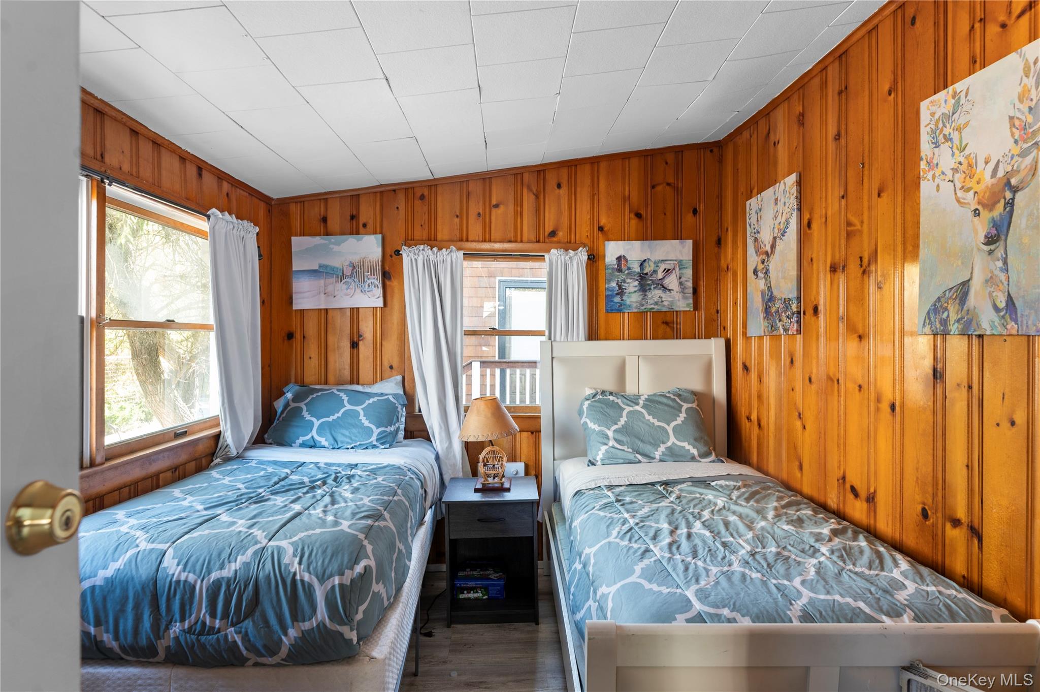 987 Surfview Walk Ocean Beach, NY 11770 - Photo 11 of 22 a bedroom with a bed and wooden floor
