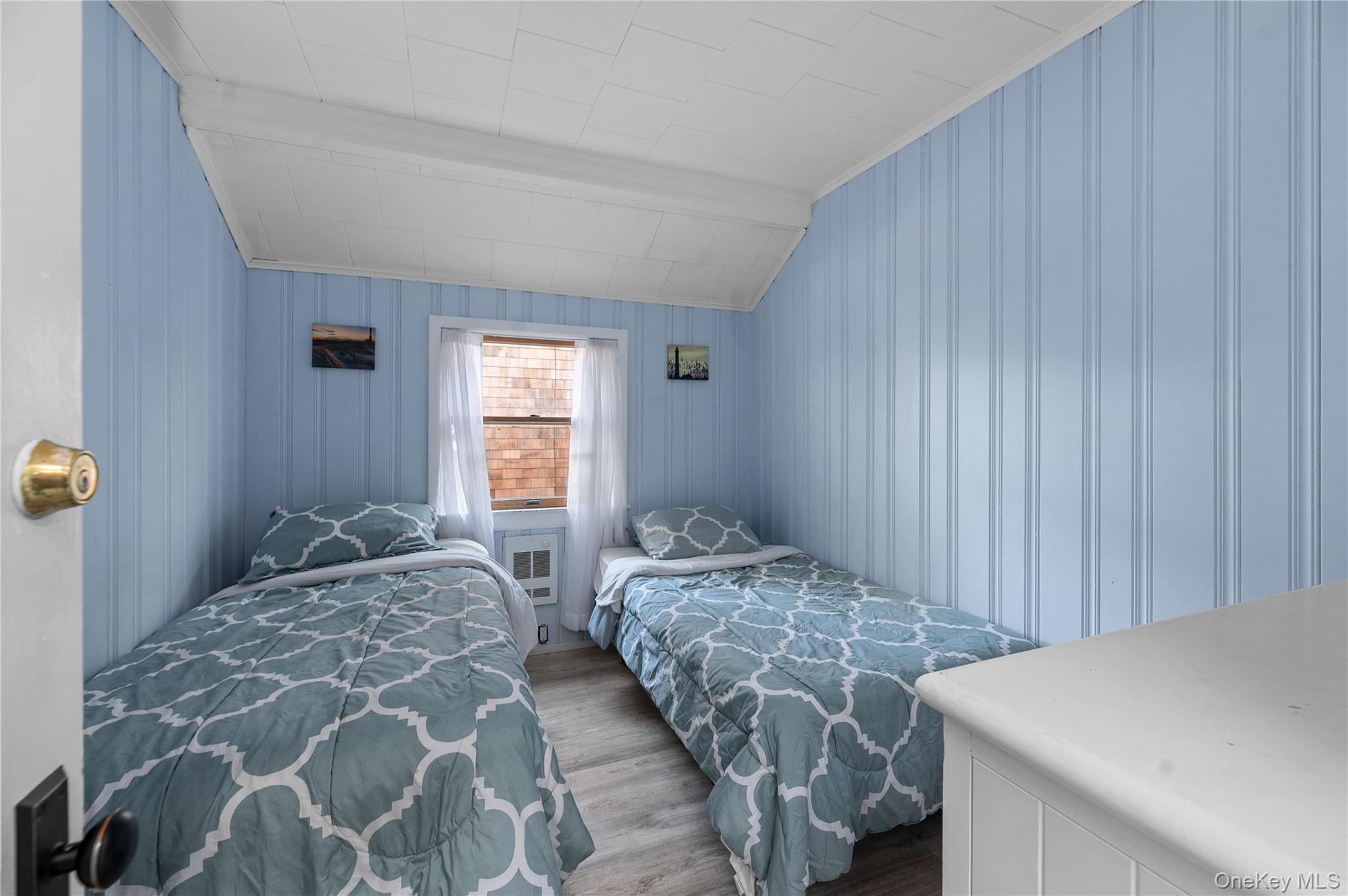 987 Surfview Walk Ocean Beach, NY 11770 - Photo 13 of 22 a bedroom with a bed and a window