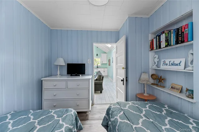 a bedroom with a bed and a television