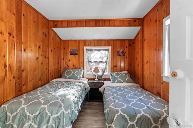 a bedroom with double bed and a window