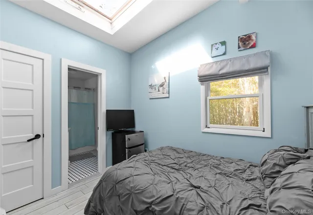 a bedroom with a bed and a tv