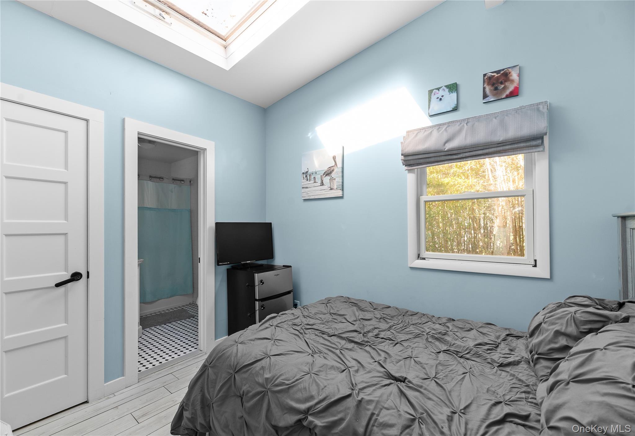 987 Surfview Walk Ocean Beach, NY 11770 - Photo 17 of 22 a bedroom with a bed and a tv