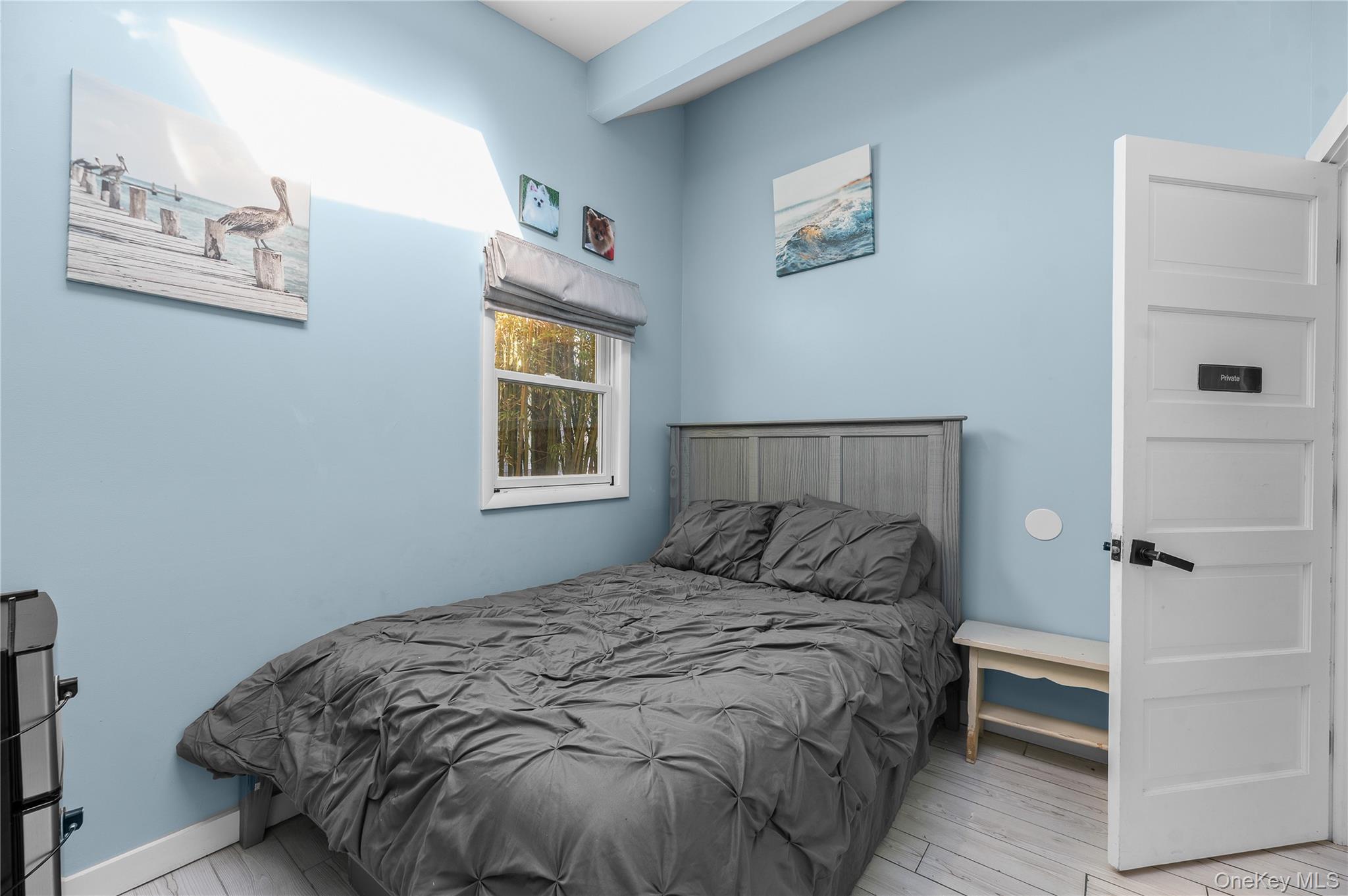 987 Surfview Walk Ocean Beach, NY 11770 - Photo 18 of 22 a bedroom with a bed and a window