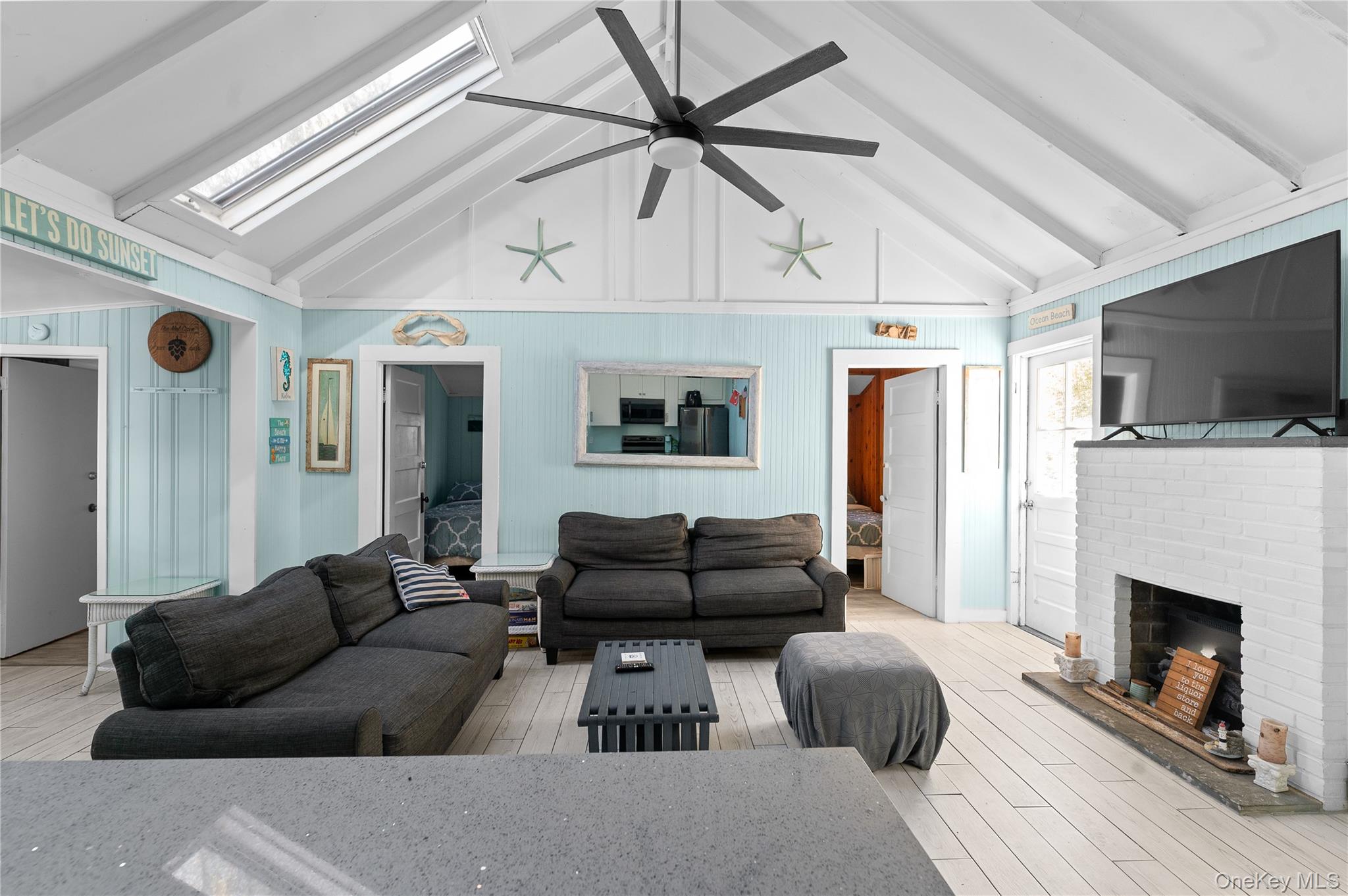 987 Surfview Walk Ocean Beach, NY 11770 - Photo 4 of 22 a living room with furniture and a fireplace