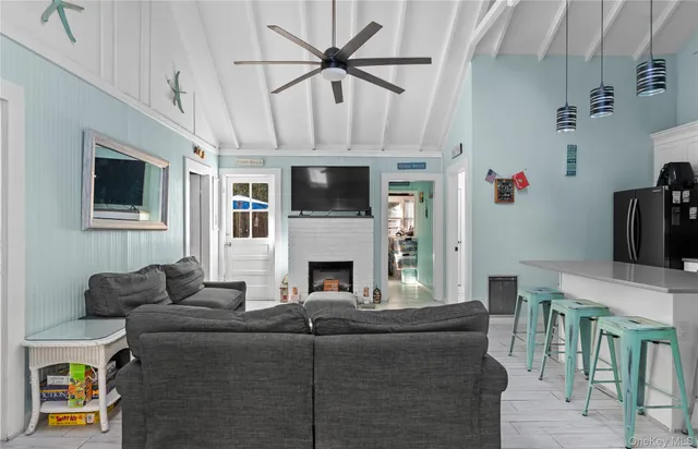 a living room with furniture a fireplace and a flat screen tv