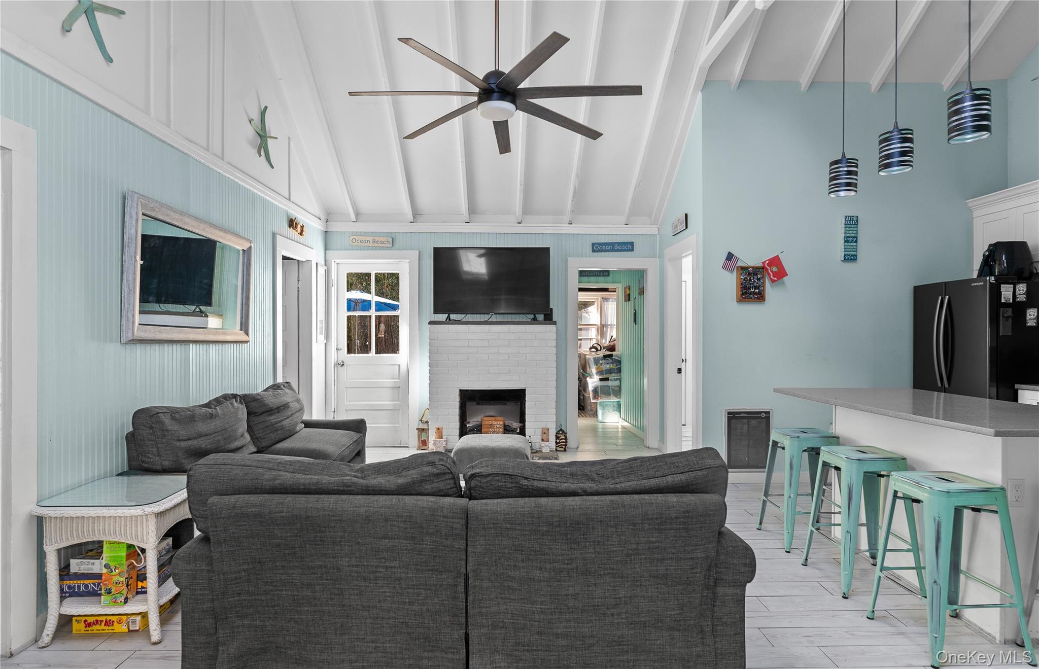 987 Surfview Walk Ocean Beach, NY 11770 - Photo 5 of 22 a living room with furniture a fireplace and a flat screen tv