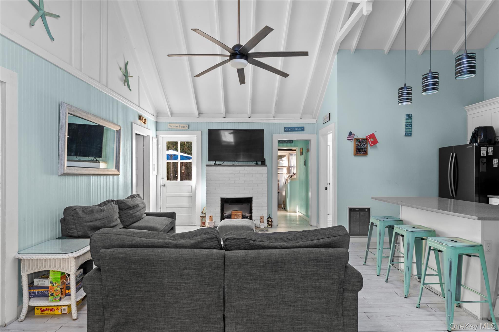 987 Surfview Walk Ocean Beach, NY 11770 - Photo 8 of 22 a living room with furniture a fireplace and a flat screen tv