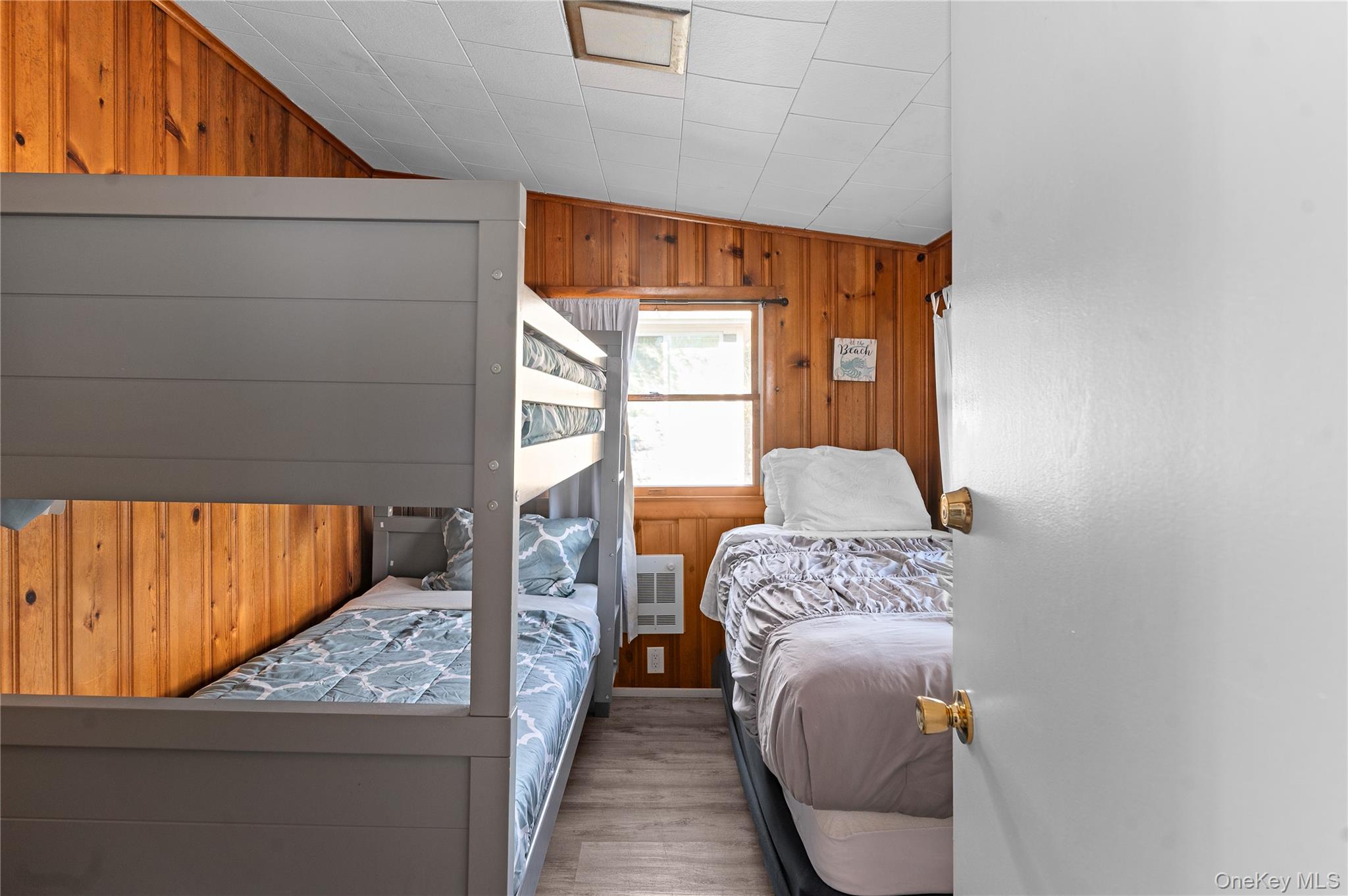 987 Surfview Walk Ocean Beach, NY 11770 - Photo 9 of 22 a bedroom with a bed and window