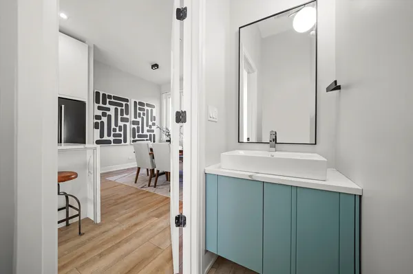 a en suite bathroom with a sink mirror and shower