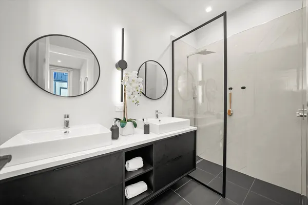 a bathroom with a double vanity sink and a mirror