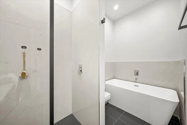 a bathroom with a tub and shower