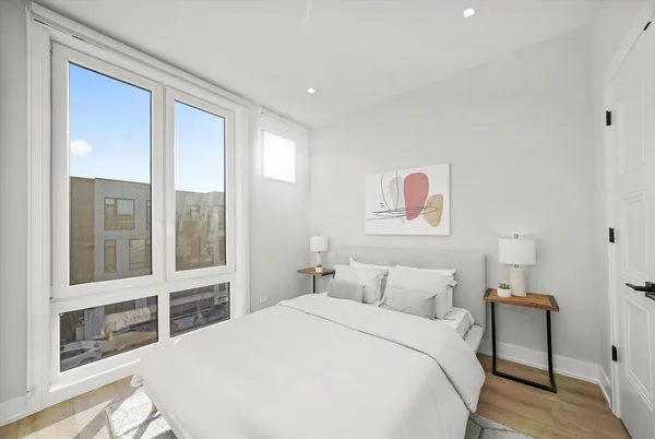 a bedroom with a large bed and a large window