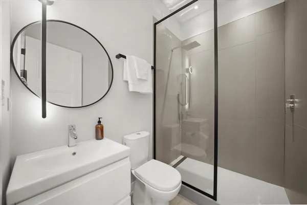 a bathroom with a sink a toilet and a mirror