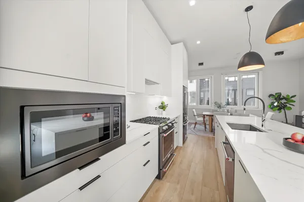 a kitchen with a stove a sink and a microwave