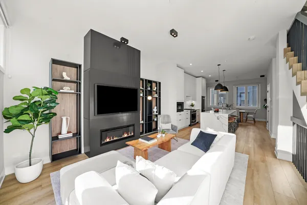 a living room with furniture potted plant and a flat screen tv
