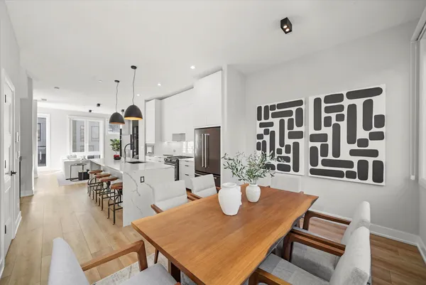 a view of a dining room with furniture and wooden floor