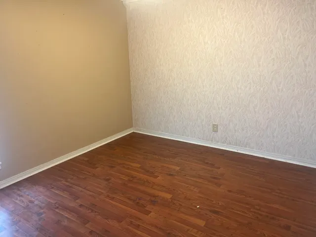 a view of a room with wooden floor