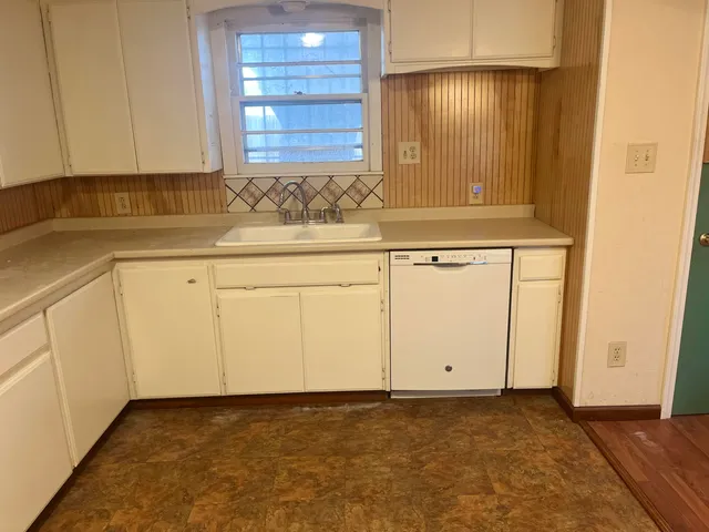 a view of wooden floor and brick walls