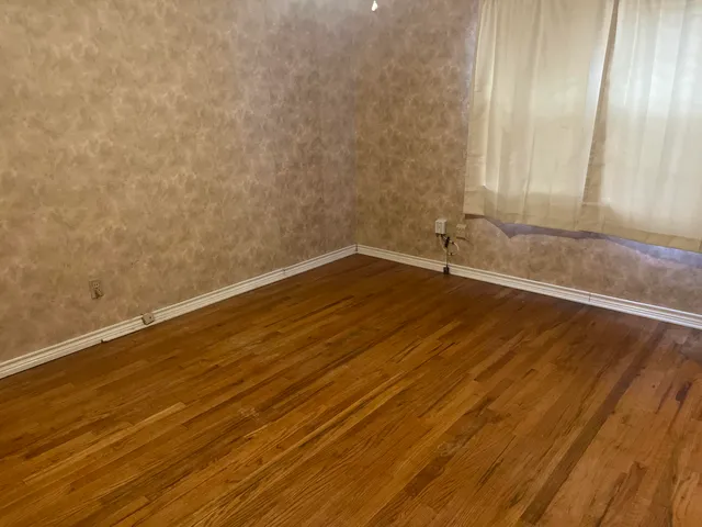 a view of wooden floor and brick walls