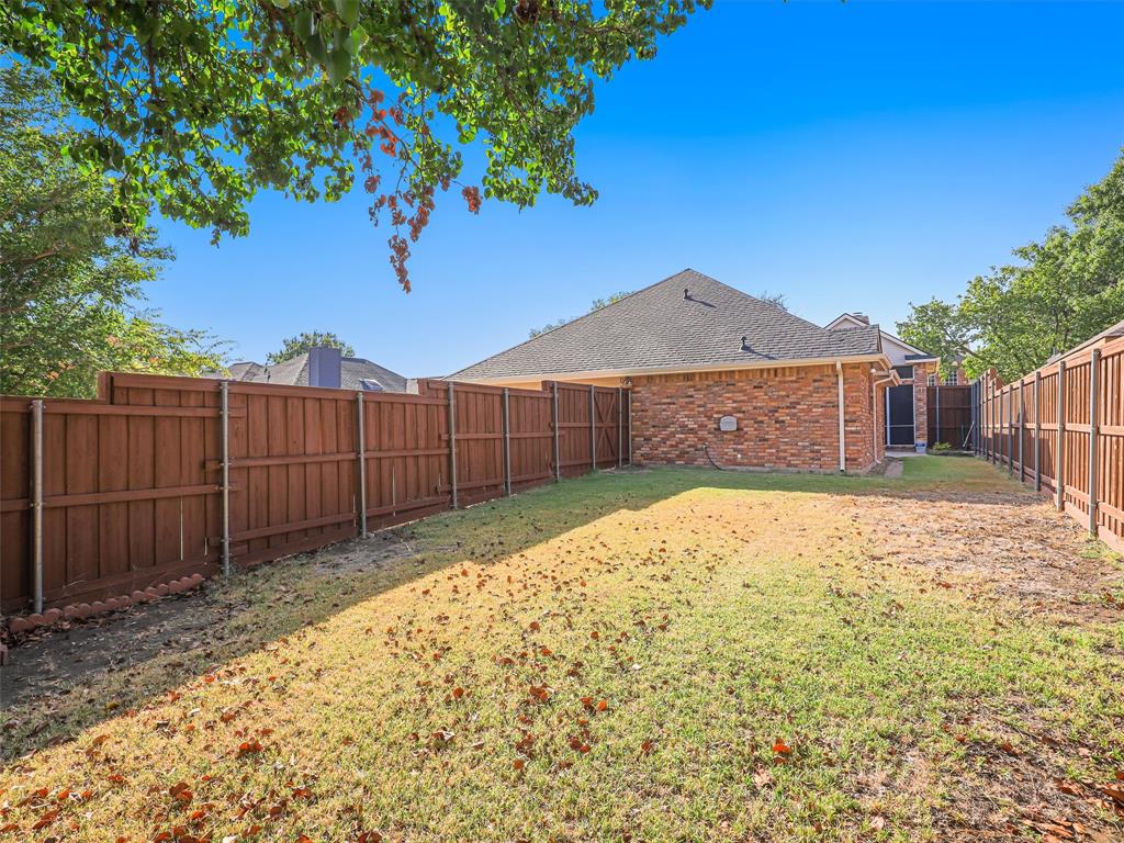 7836 Tournament Road Frisco, TX 75035 - Photo 23 of 23 Expansive fenced backyard featuring a brick exterior and a privacy fence