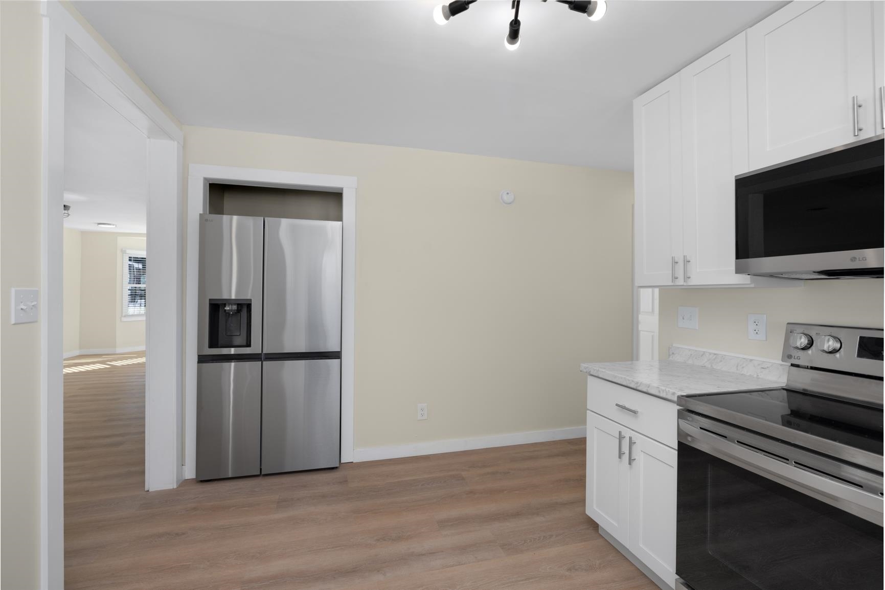114 Boyce Avenue Covington, TN 38019 - Photo 11 of 24 a kitchen with a refrigerator and a stove top oven