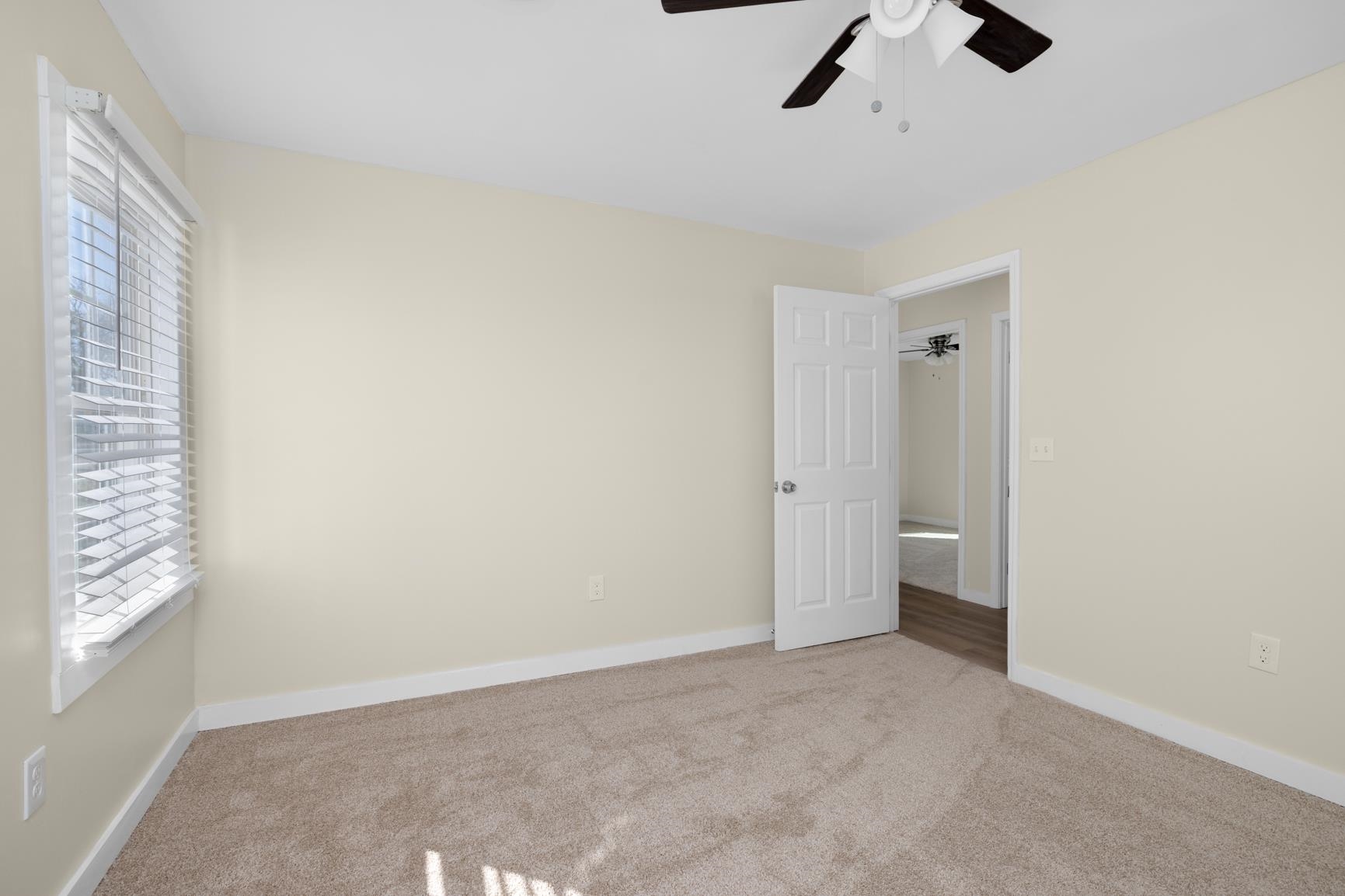 114 Boyce Avenue Covington, TN 38019 - Photo 16 of 24 an empty room with windows and fan