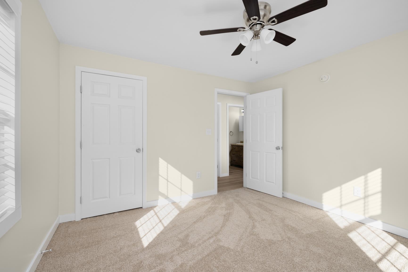 114 Boyce Avenue Covington, TN 38019 - Photo 18 of 24 a view of a room with a ceiling fan and carpet