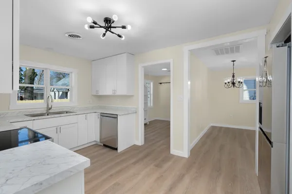 a kitchen with a refrigerator and a sink
