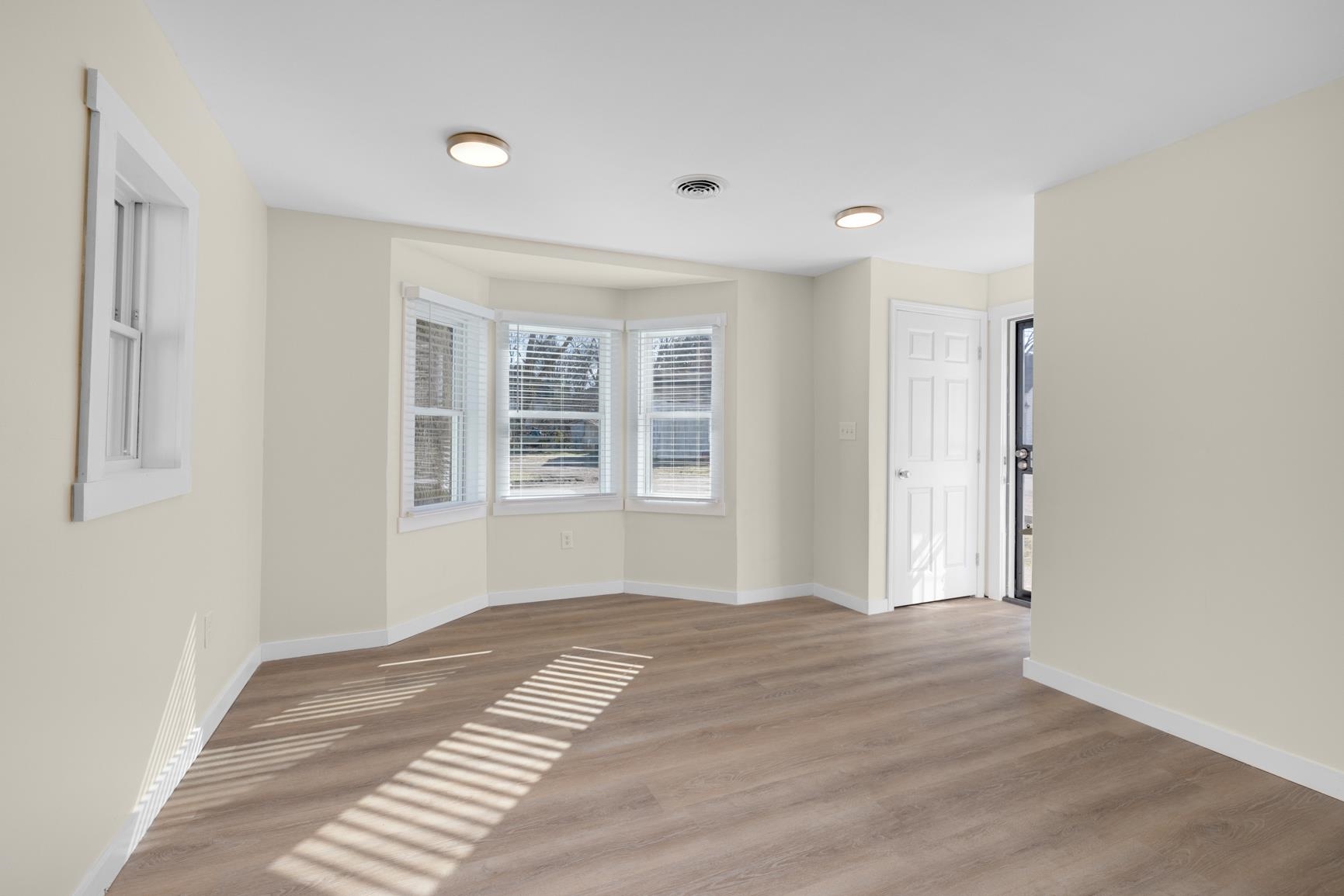 114 Boyce Avenue Covington, TN 38019 - Photo 6 of 24 a view of empty room with wooden floor and fan
