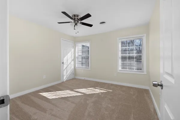 a view of a livingroom with a ceiling fan and window