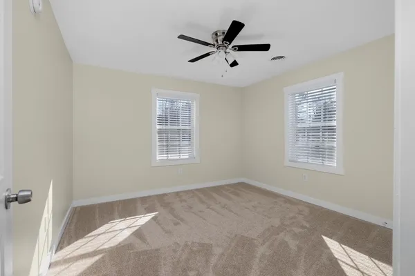 a view of a livingroom with a ceiling fan and window