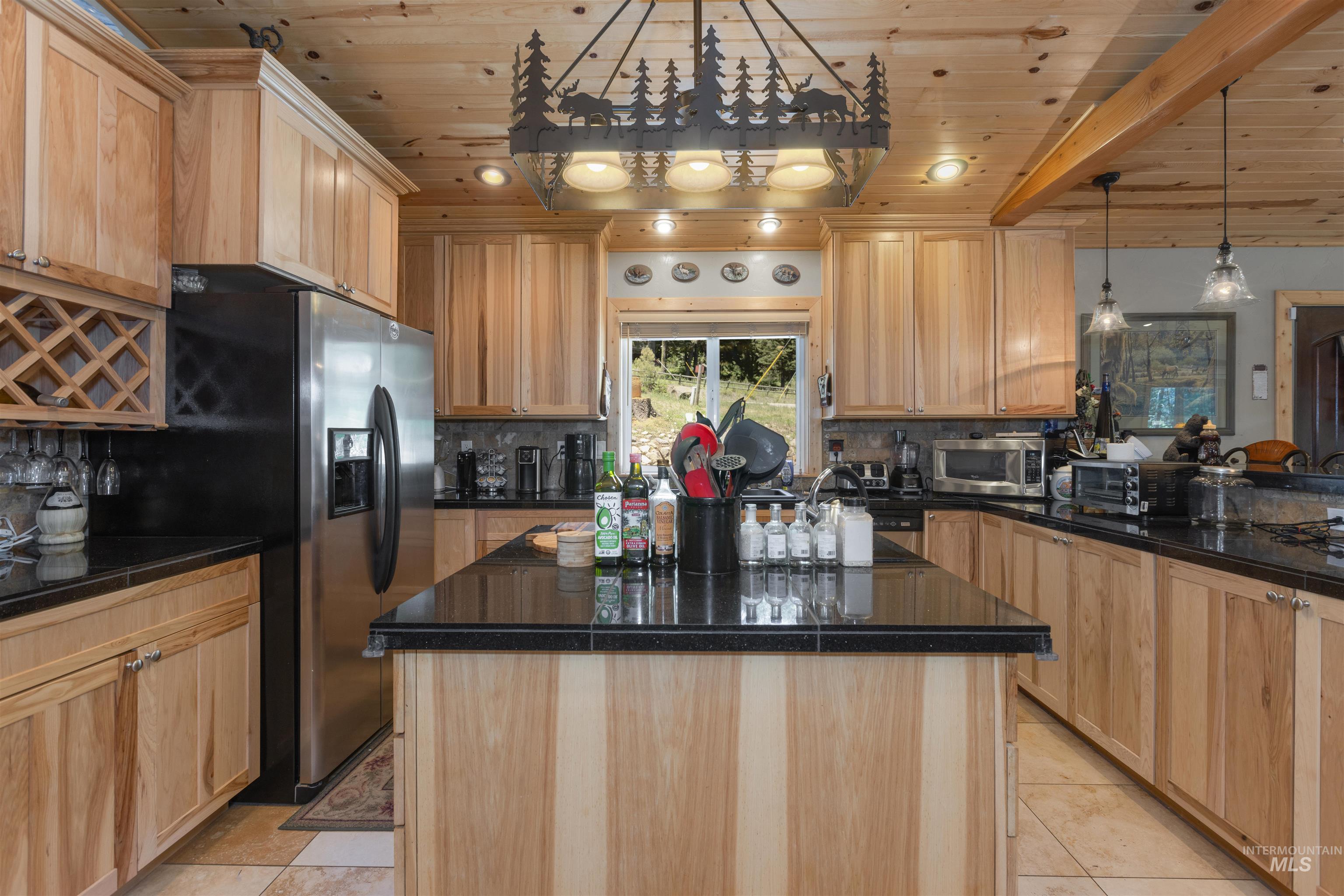 1 Miller Lane Cascade, ID 83611 - Photo 11 of 39 Kitchen featuring light brown cabinets, stainless steel appliances, wooden ceiling, and tasteful backsplash
