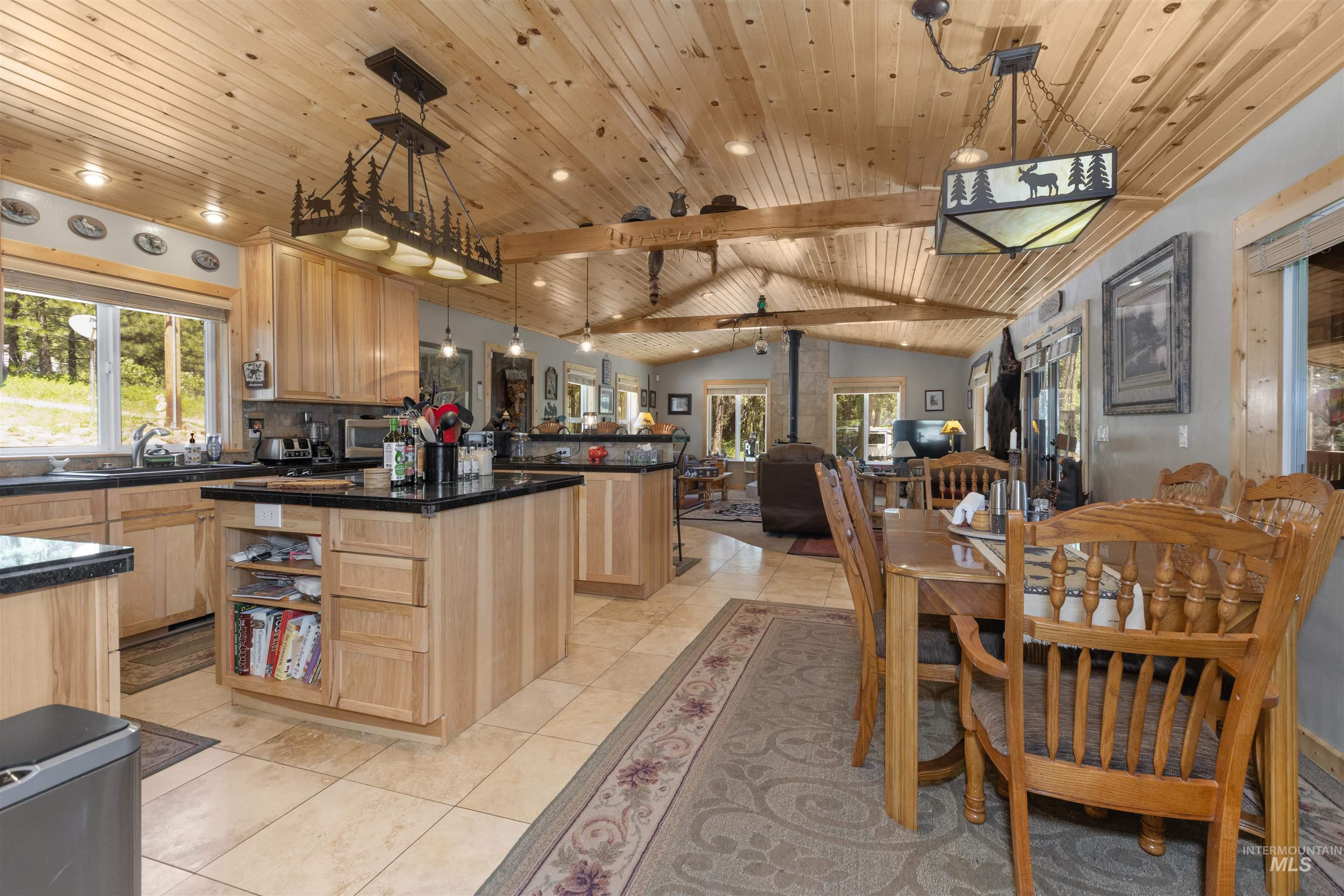 1 Miller Lane Cascade, ID 83611 - Photo 39 of 39 Kitchen featuring light brown cabinetry, wooden ceiling, dark countertops, healthy amount of natural light, and open floor plan