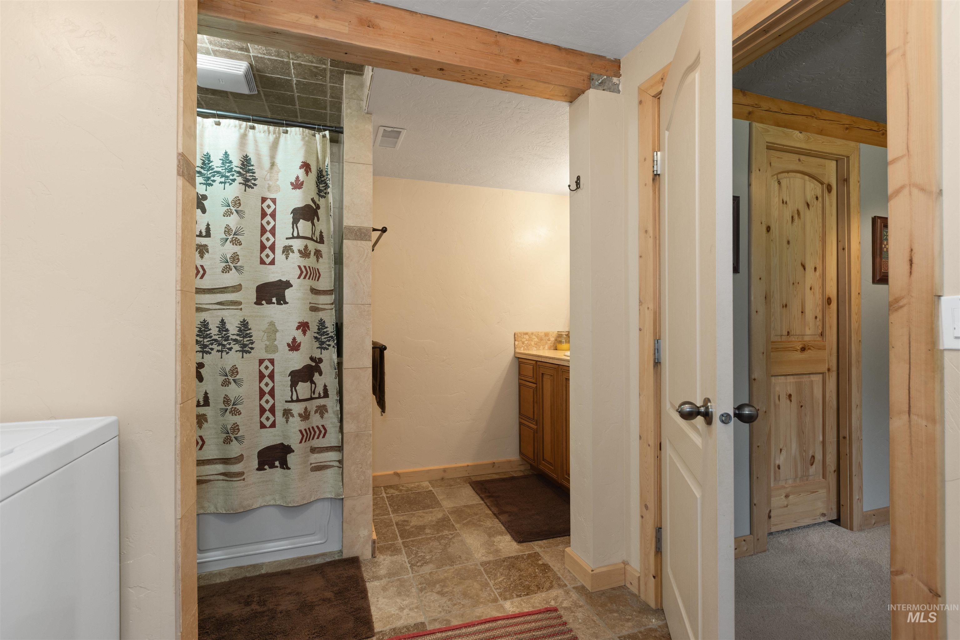 1 Miller Lane Cascade, ID 83611 - Photo 21 of 39 Full bath with vanity, washer / clothes dryer, and stone finish flooring