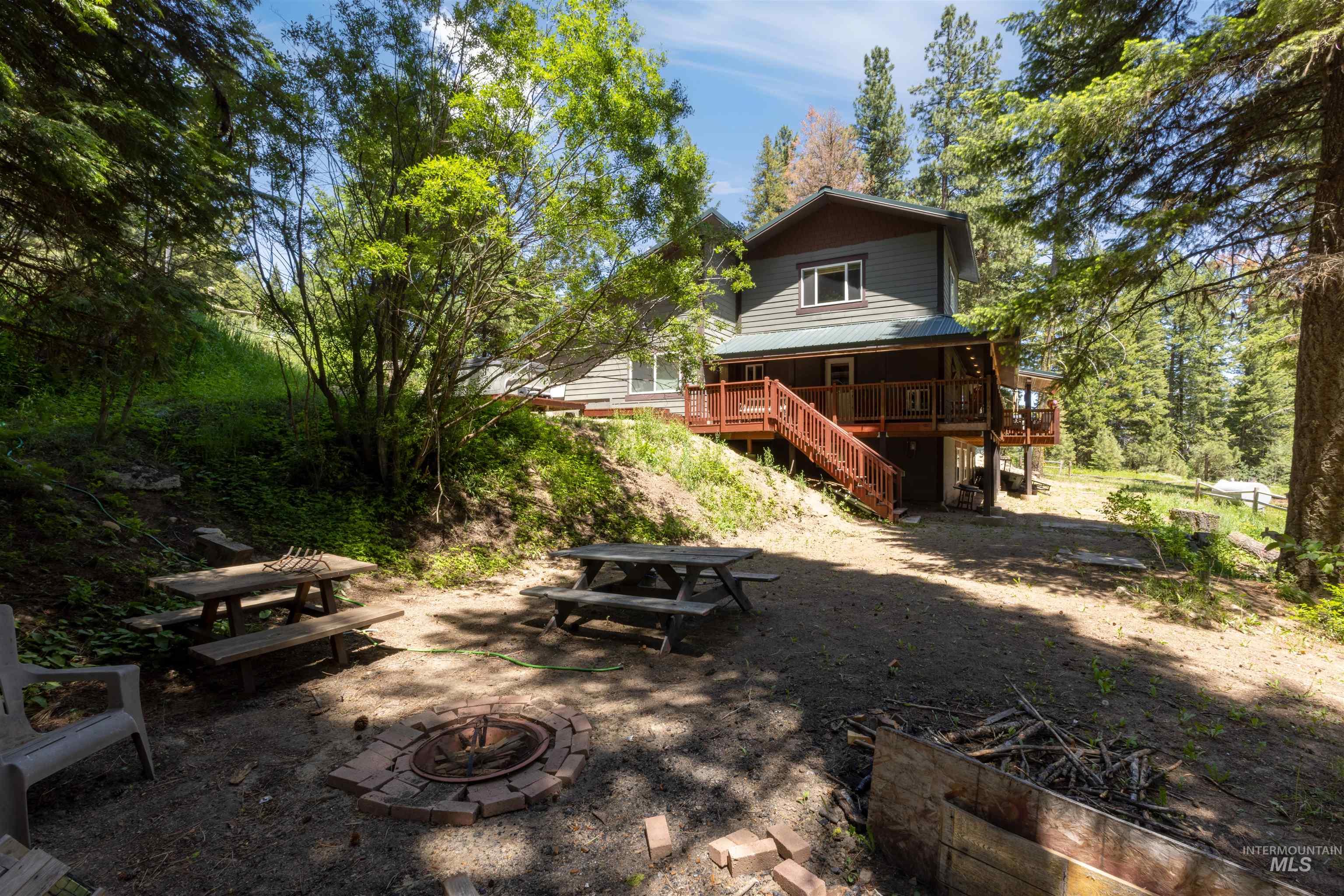 1 Miller Lane Cascade, ID 83611 - Photo 32 of 39 View of yard with an outdoor fire pit, stairway, and a wooden deck