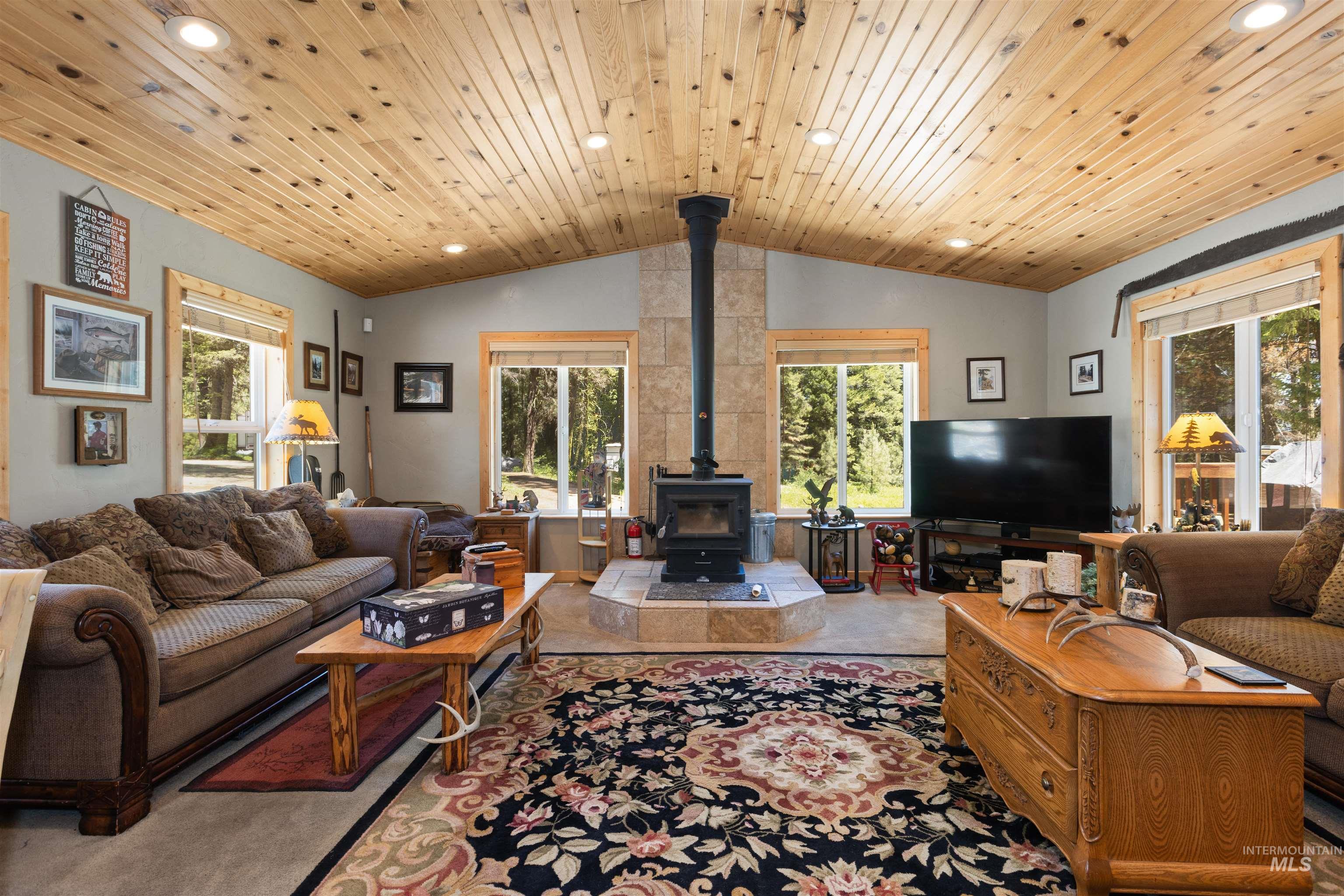 1 Miller Lane Cascade, ID 83611 - Photo 7 of 39 Living area featuring a wood stove, recessed lighting, vaulted ceiling, healthy amount of natural light, and wooden ceiling