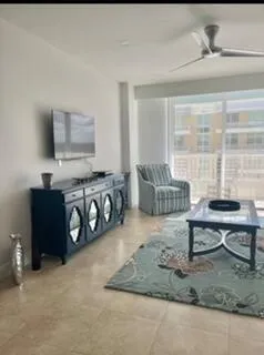 a living room with furniture and a flat screen tv