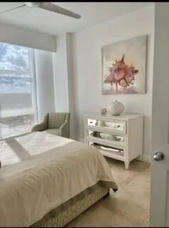 a bedroom with a bed and a painting on the wall