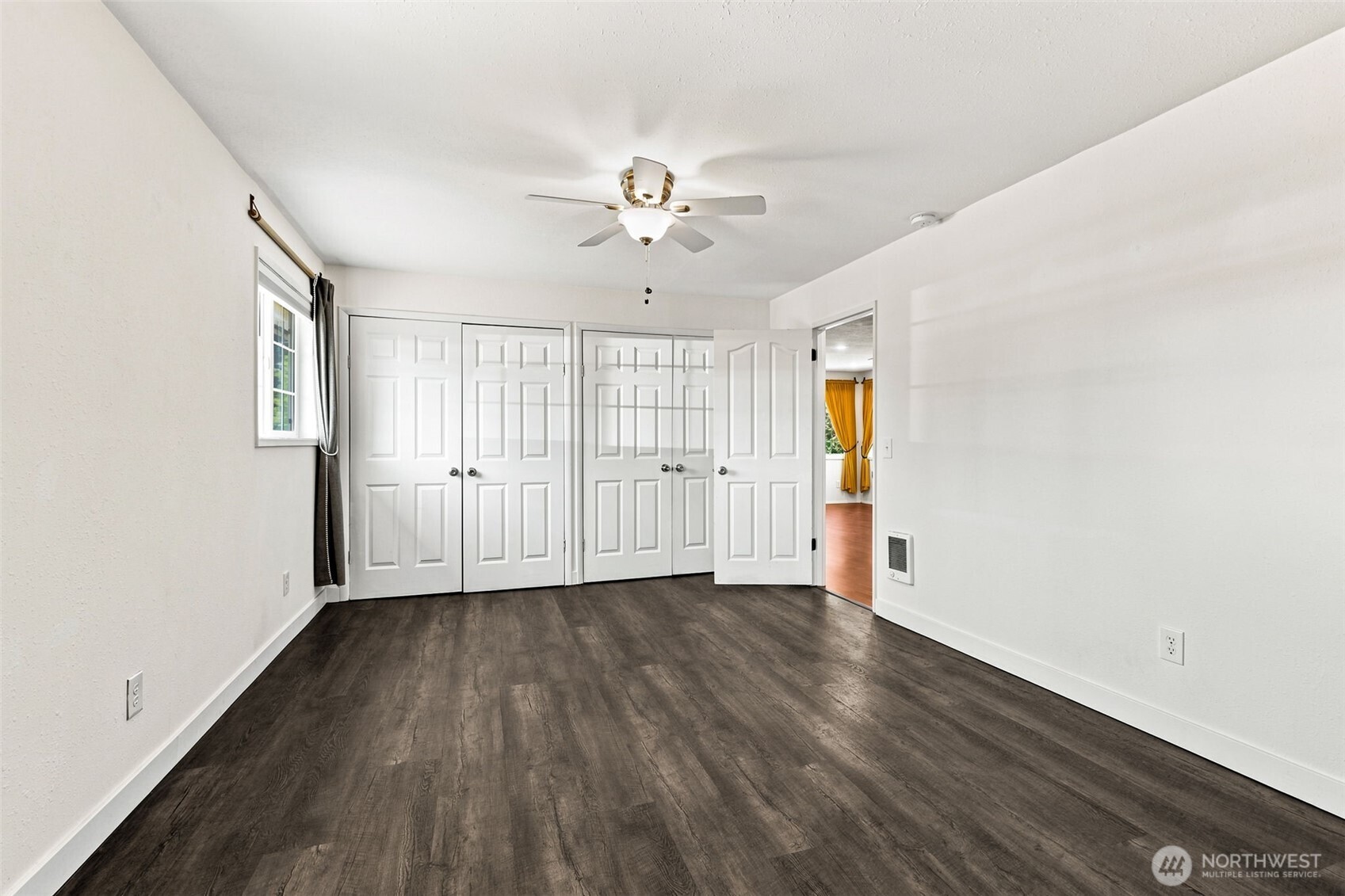 158 Gharet Road Randle, WA 98377 - Photo 14 of 25 an empty room with wooden floor ceiling fan and windows