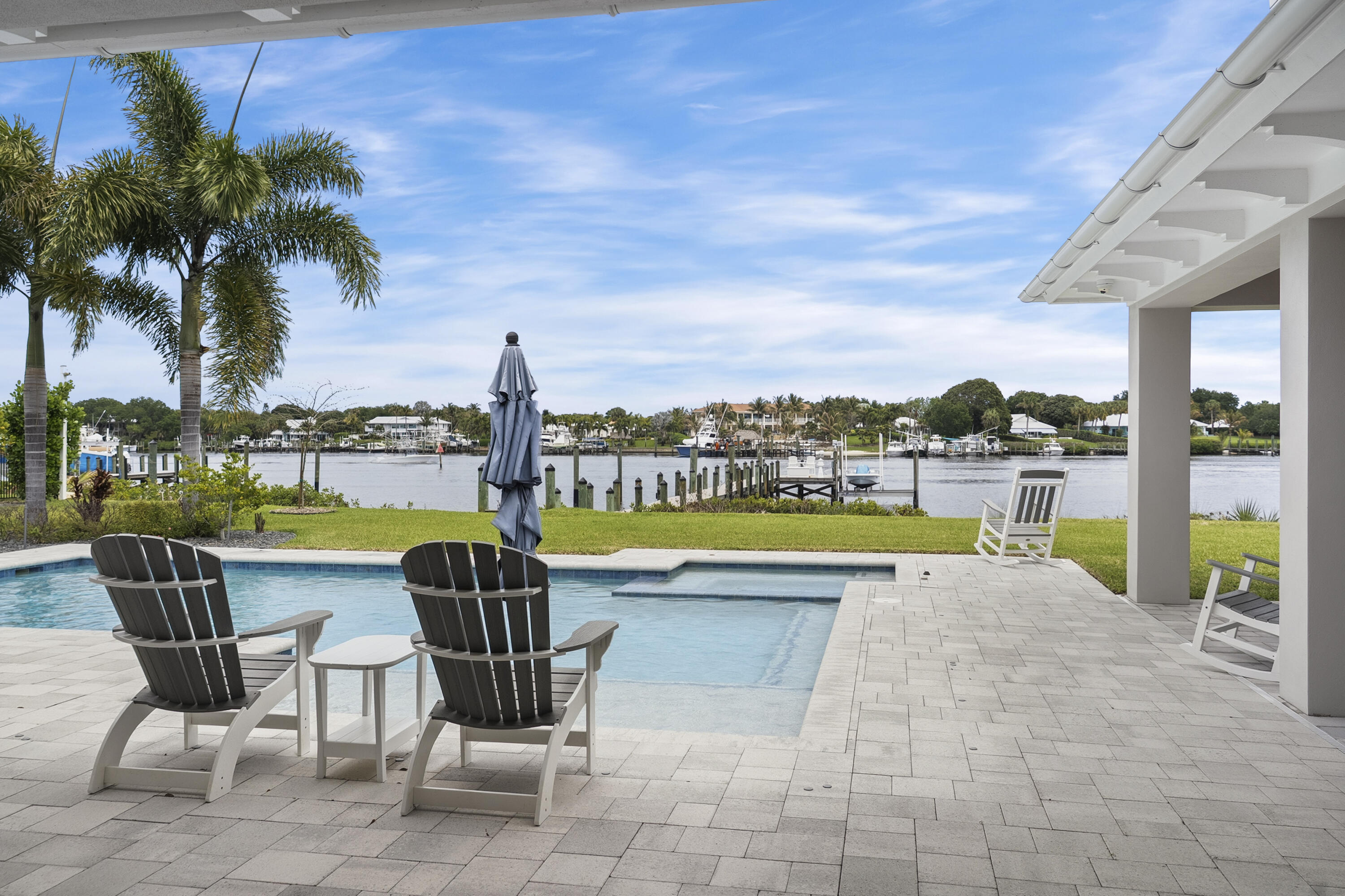 3973 Southeast Topsail Court Stuart, FL 34997 - Photo 3 of 38 a view of a swimming pool and outdoor seating