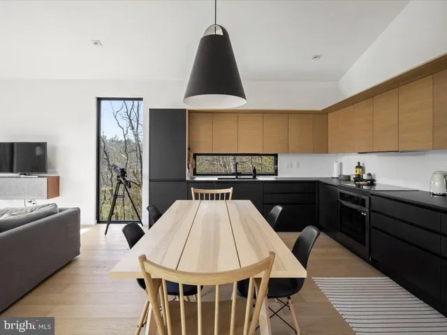 a kitchen with a wooden table and chairs